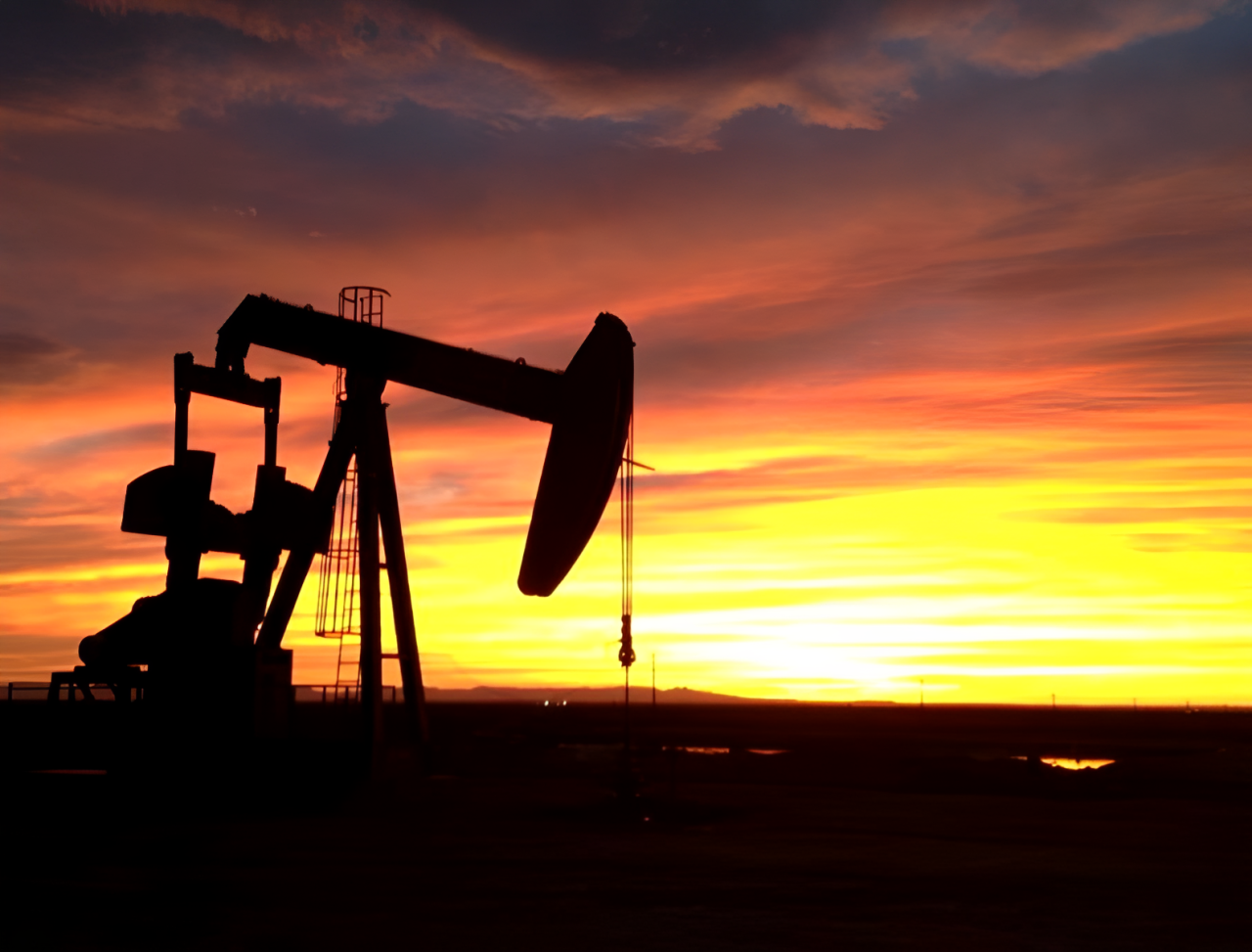 Oil pumpjack silhouette at sunset